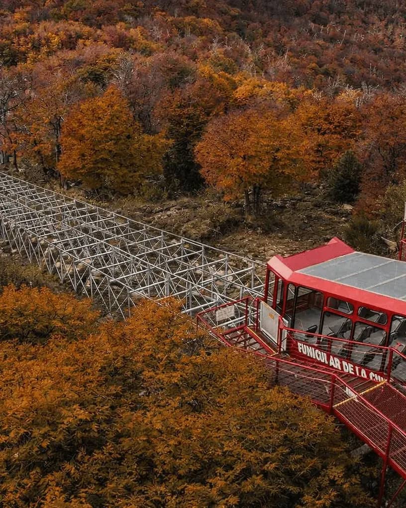 Top view of the funicular at the upper station with an autumnal background