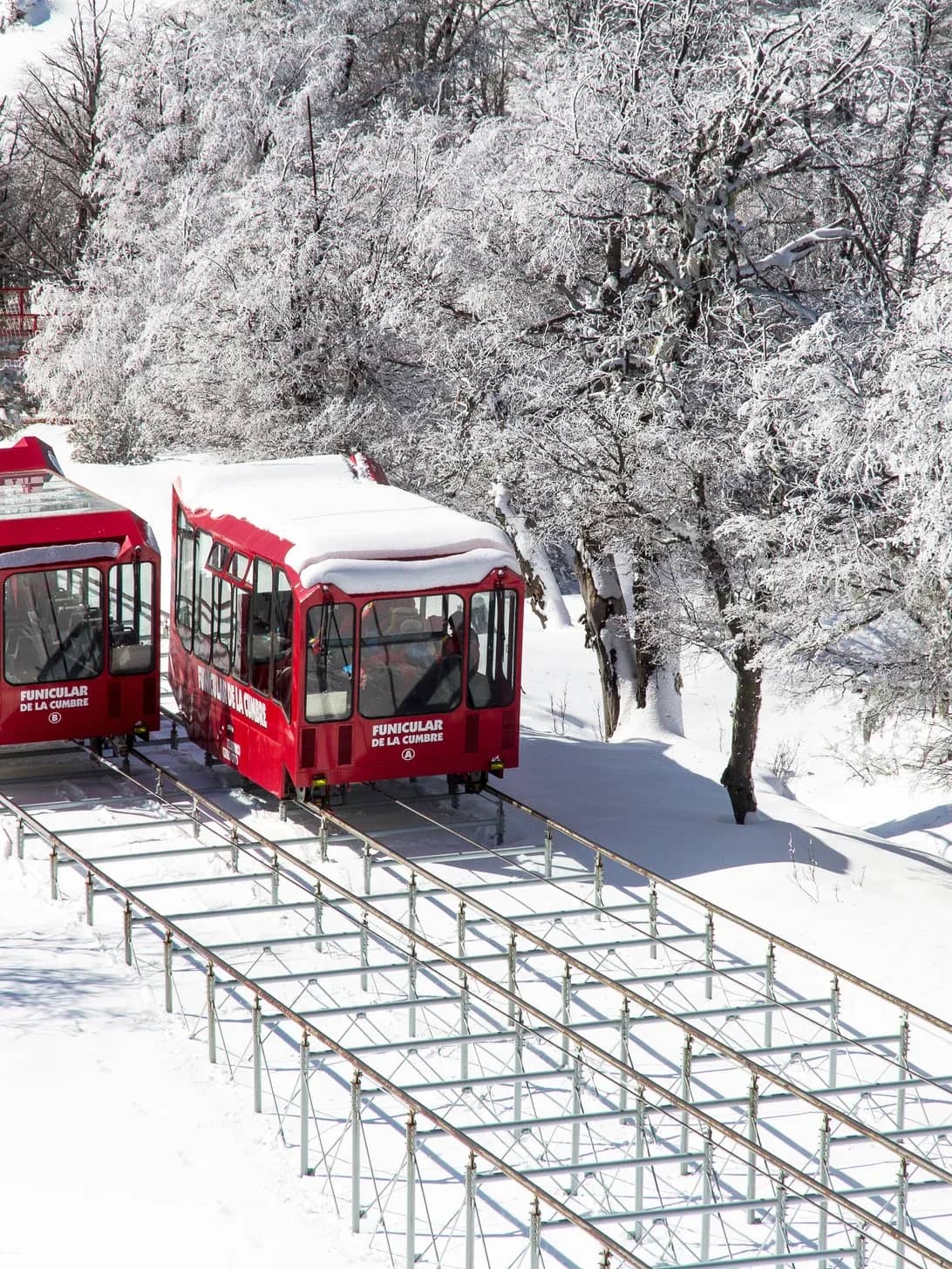 Panoramic view of the funicular at the summit, showing its entire route and mountains in the background.