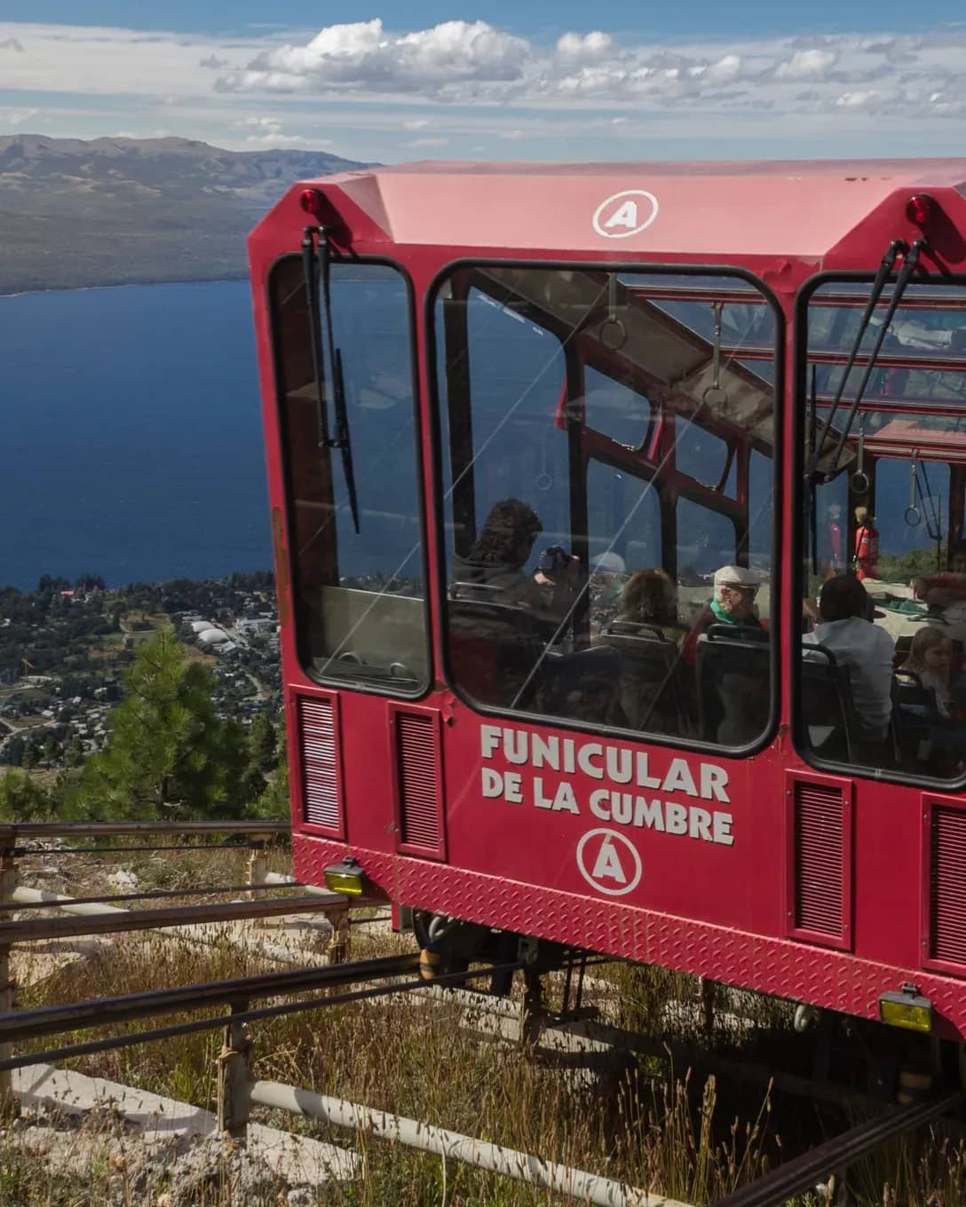 Front of the funicular arriving at its upper station with Lake Nahuel Huapi in the background on a sunny day